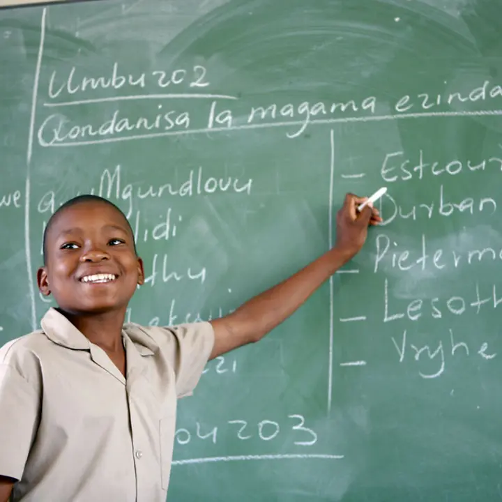Unser Bildungsprogramm 'Schulen für Afrika' ermöglicht den Kindern Afrikas den Schulbesuch. | © UNICEF/Pirozzi Schulen in Afrika: Ein Junge steht in einem Klassenzimmer an einer Tafel.