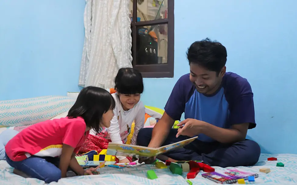 Kimy lernt und spielt mit ihrem Vater und ihrer Schwester. | © UNICEF/Veska Indonesien: Kimy lernt und spielt zuhause mit ihrem Vater und ihrer Schwester.