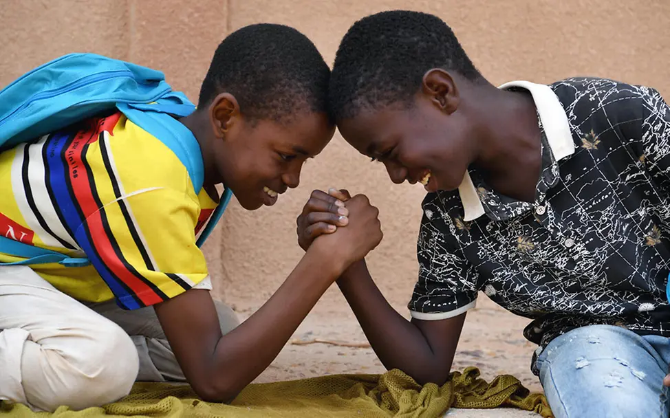 Zwei Freunde aus Niger beim Armdrücken. | © UNICEF/Dejongh Niger: Zwei Freunde beim Armdrücken.