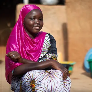 Mädchen Bildung in Mali: Die 15-jährige Hawa sitzt vor ihrem Haus