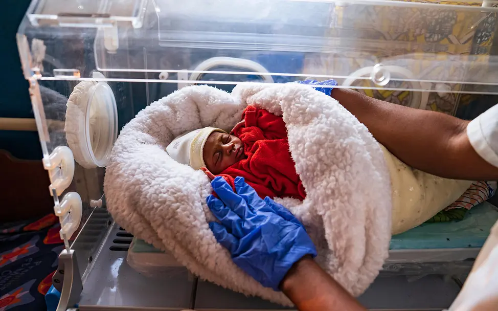 Medizinische Hilfe Spenden: Ein hilfsbedürftiges Baby liegt in einem Inkubator. 