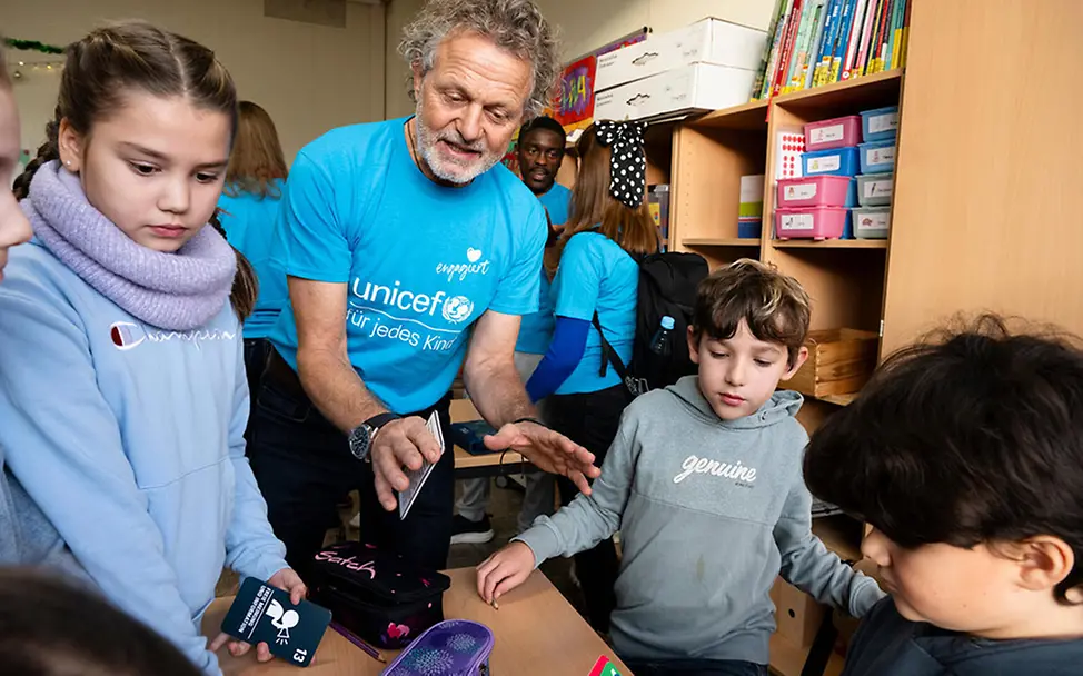 Ehrenamtliches Engagement für UNICEF: Engagierte unterstützen Kinder in der Schule.