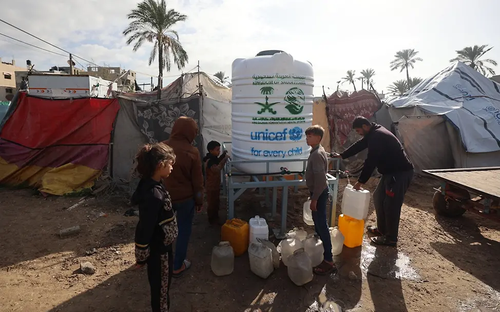 Kinder holen Wasser an einem Wassertank | UNICEF/Eleyan Gaza: Kinder stehen vor einem Wassertank