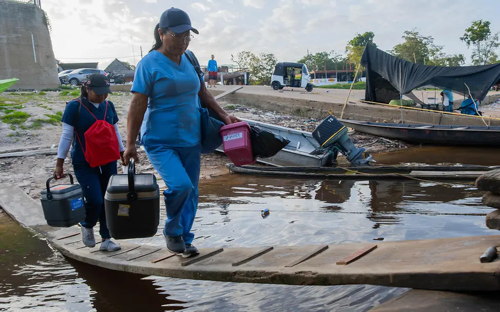 UNICEF liefert Impfstoffe auch in die entlegensten Gebiete, damit mehr Kinder gesund aufwachsen können. | © UNICEF Impfen einfach erklärt: Zwei Gesundheitshelferinnen steigen mit Impfstoffen auf ein Boot.